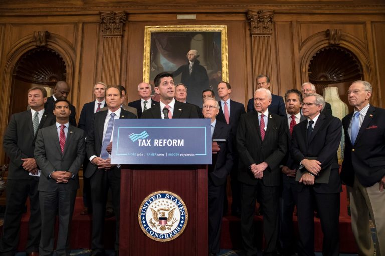 FILE - In this Wednesday, Sept. 27, 2017, file photo, Speaker of the House Paul Ryan, R-Wis., at podium, speaks about the Republicans' proposed rewrite of the tax code for individuals and corporations, at the Capitol in Washington. President Donald Trump and congressional Republicans are writing a far-reaching, $5.8 trillion plan they say would simplify the tax system and nearly double the standard deduction used by most Americans. (AP Photo/J. Scott Applewhite, File)