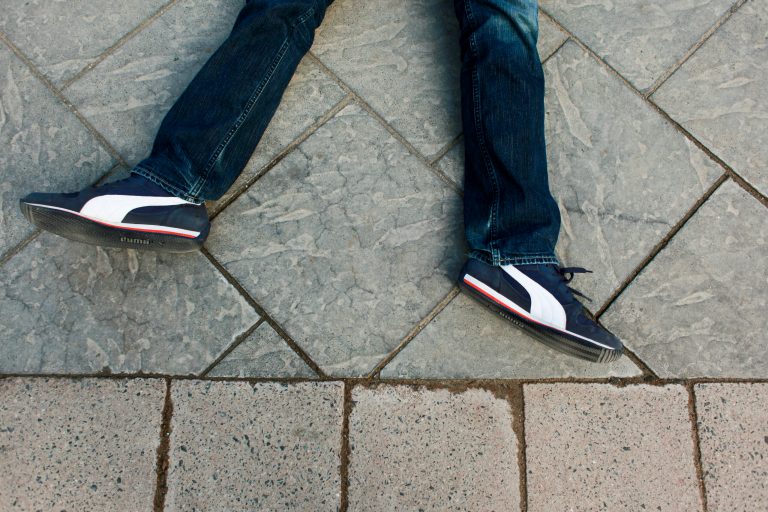 A protester participates in a die-in on Thursday afternoon, Dec. 4, 2014, at Campus Martius park in downtown Detroit in a rally over the non-indictment of Eric Garner, a black New York man who died during a police arrest. (AP Photo/The Grand Rapids Press, Elaine Cromie )