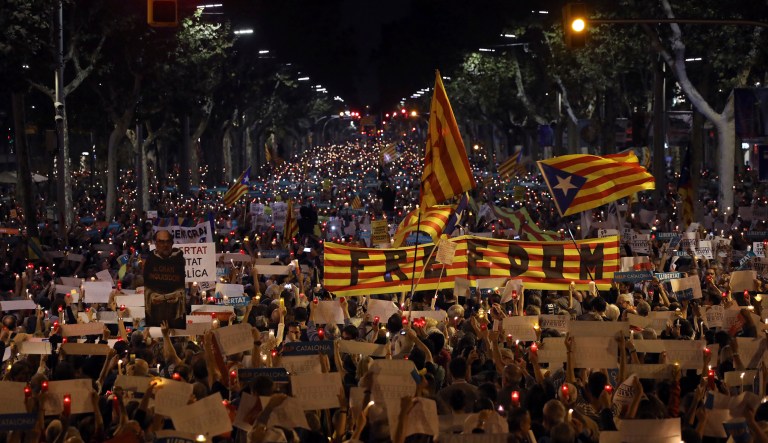 FILE - In this Tuesday, Oct. 17, 2017 file photo people gather to protest against the National Court's decision to imprison civil society leaders without bail, in Barcelona, Spain. (AP Photo/Emilio Morenatti, File)