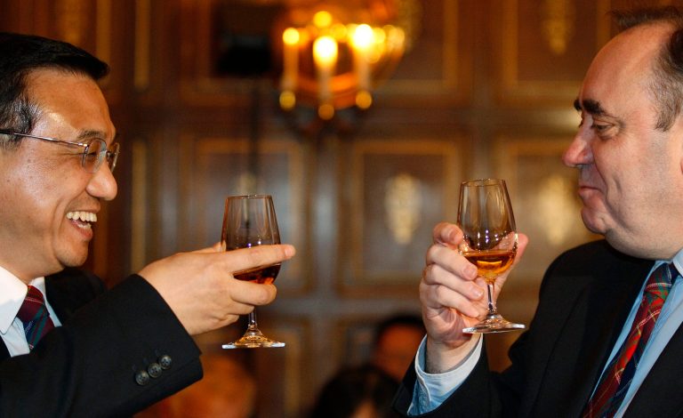 FILE - In this is Jan. 9, 2011, file photo China's Vice Premier Li Keqiang, left, laughs as he raises a glass of whisky to Scotland's First Minister Alex Salmond before attending a state dinner at Edinburgh castle in Edinburgh, Scotland. Distilleries need to have long-term plans for investments and financing, all of which could be thrown into turmoil on Sept. 18, 2014, when Scotland votes on whether to leave Britain. Whisky makers and other businesses are worried about the risks involved in finding themselves in a new country with, among other things, a different currency.(AP Photo/David Moir, Pool, File)
