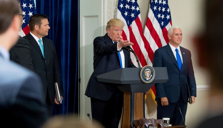 President Donald Trump, accompanied by Vice President Mike Pence, right, and Kansas Secretary of State Kris Kobach, left, speaks during the first meeting of the Presidential Advisory Commission on Election Integrity at the Eisenhower Executive Office Building on the White House complex in Washington, Wednesday, July 19, 2017. (AP Photo/Andrew Harnik)