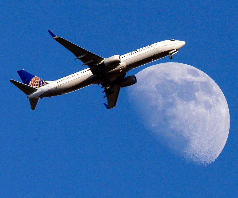 FILE - In this July 17, 2013 file photo, a United Airlines jet plane landing at Los Angeles International Airport, in Whittler City  Calif., passes in front of a Waxing Gibbous moon. United Airlines reports quarterly earnings on Thursday, April 24, 2014. ( AP Photo/Nick Ut, File)