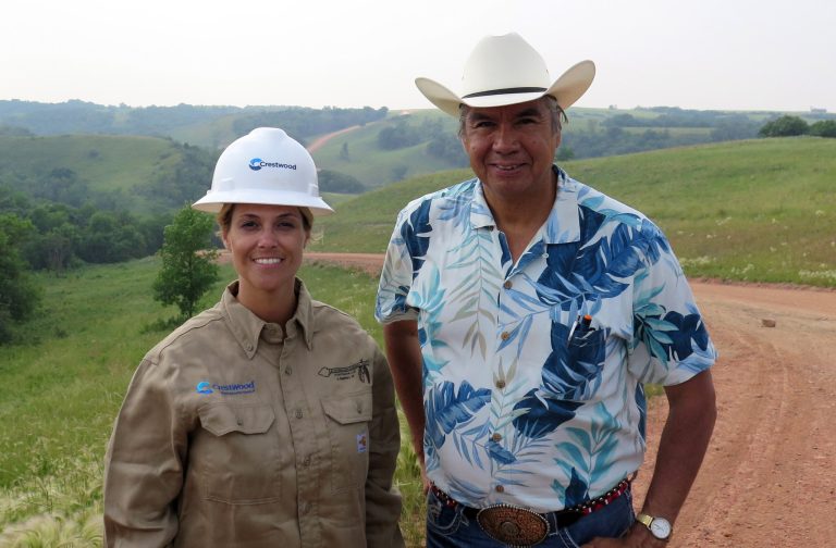 Miranda Jones, vice president of environmental safety and regulatory at Crestwood Midstream Partners, and Tex Hall, chairman of the Three Affiliated Tribes, pose for a photo near the site of a pipeline spill near Mandaree, N.D., Wednesday, July 9, 2014. A pipeline owned by a Crestwood subsidiary leaked around 1 million gallons of saltwater. Some of that liquid entered a bay that leads to a lake that is used for drinking water by the Three Affiliated Tribes. (AP Photo/Josh Wood)