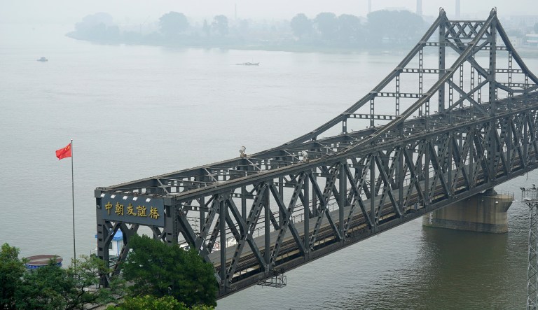 A Chinese flag flies over the Chinese end of the Friendship Bridge connecting China and North Korea. China has tightened restrictions on trade with North Korea under U.N. nuclear sanctions, imposing a cap on oil supplies to the North and banning imports of its steel and other goods. (AP Photo/Emily Wang, File)