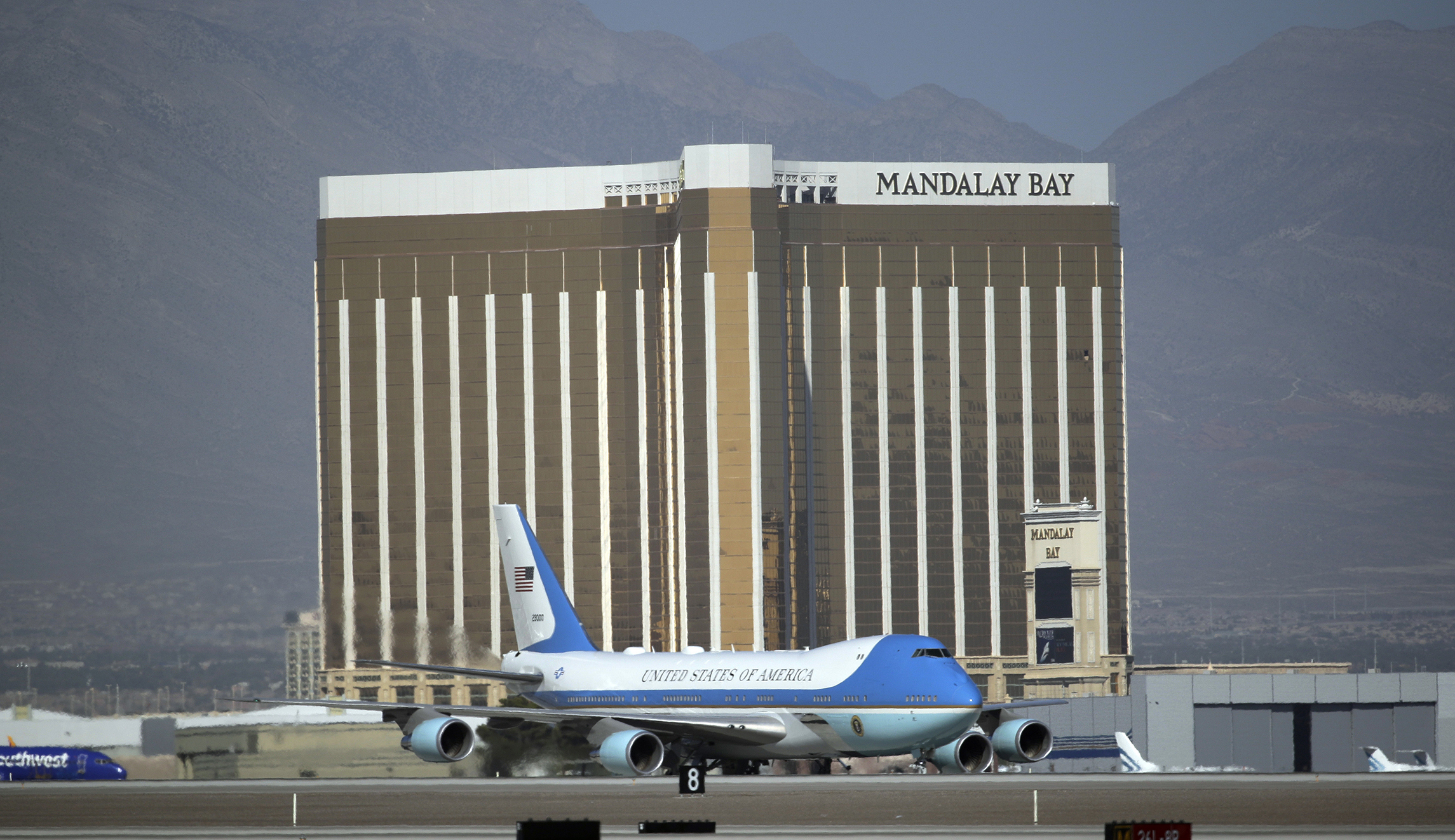Air Force One pictured flying behind Mandalay Bay windows broken in Las Vegas shooting