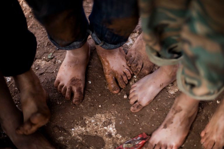 FILE - In this file photo taken Friday, Oct. 26, 2012, displaced Syrian children gather barefoot in a refugee camp near Atma, Idlib province, Syria. Children in Syria have been tortured, maimed and sexually abused by President Bashar Assad's forces and recruited for combat by the rebels fighting to topple him, according to a new United Nations report, posted on the U.N. website late Tuesday, Feb. 4, 2014. (AP Photo/Manu Brabo, File)