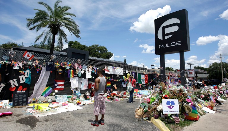 Visitors gather at a makeshift memorial outside the Pulse nightclub in Orlando, Fla. Congressional leaders Monday remembered the 49 people killed in last year's terror attack on Pulse Nightclub in Orlando. (AP Photo/John Raoux, File)