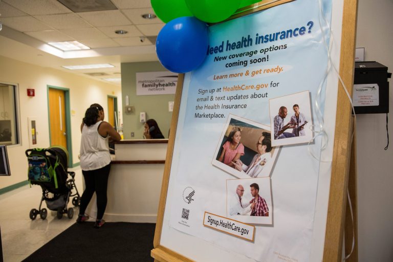 A sign encouraging uninsured people to sign up for the Affordable Care Act, better known as ObamaCare, is displayed for patients as they enter a branch of the Metopolitan Family Health networt on Oct. 3 in Jersey City, New Jersey. (Andrew Burton/Getty Images)