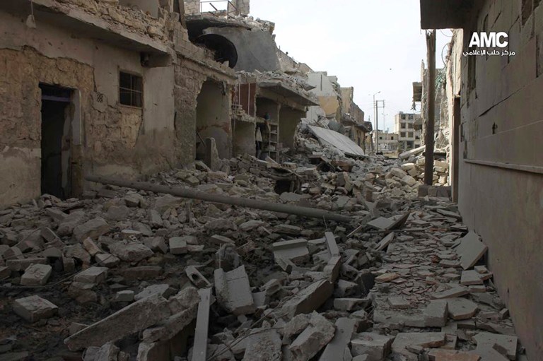 In this Sunday Feb. 2, 2014 citizen journalism image provided by Aleppo Media Center (AMC), an anti-Bashar Assad activist group, which has been authenticated based on its contents and other AP reporting, shows buildings damaged by Syrian government forces airplanes, in Aleppo, Syria. Syrian government helicopters and warplanes unleashed a wave of airstrikes on more than a dozen opposition-held neighborhoods in the northern city of Aleppo on Sunday, firing missiles and dropping crude barrel bombs in a ferocious attack that killed dozens of people, including at least 17 children, activists said. (AP Photo/Aleppo Media Center, AMC)