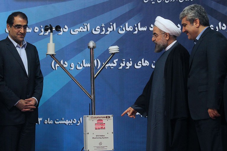 In this photo released by the official website of the office of the Iranian Presidency, Iran's President Hassan Rouhani, second right, points a UV-Index Monitoring System, a device to measure the level of the ultraviolet radiation (UV), as he unveils it in a ceremony in Tehran, Iran, Sunday, May 11, 2014. Rouhani said Sunday his country has nothing to offer except transparency in nuclear talks with world powers, rebuffing hard-liners as negotiators seek a final deal over the Islamic Republic's contested program. He is accompanied by Vice President for science and technology affairs Sorena Sattari, right, and Health Minister Hassan Hashemi. (AP Photo/ Iranian Presidency Office, Mohammad Berno)