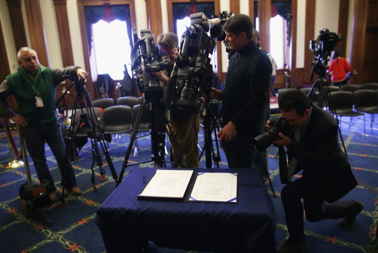 Member of the media photograph a signed Keystone XL Pipeline Approval Act after a signing ceremony in the Rayburn Room of the Capitol February 13, 2015 on Capitol Hill in Washington, DC. (Photo by Alex Wong/Getty images)
