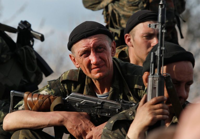 Soldiers from the Ukrainian Army sit atop combat vehicles as they are blocked by people on their way to the town of Kramatorsk, Wednesday, April 16, 2014. Pro-Russian insurgents commandeered six Ukrainian armored vehicles along with their crews and hoisted Russian flags over them Wednesday, dampening the central government's hopes of re-establishing control over restive eastern Ukraine. (AP Photo/Sergei Grits)