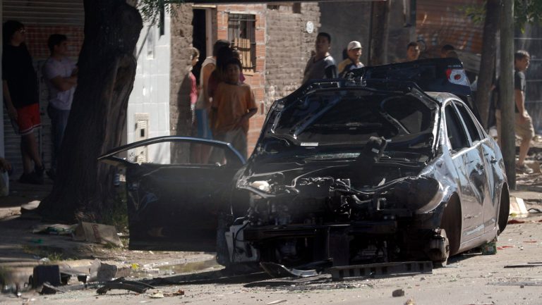   A damaged car is seen on the street after looters tried to enter a supermarket on the outskirts of Buenos Aires, Argentina, Friday, Dec. 21, 2012. Two people were killed in Argentina as looters ransacked supermarkets in several cities, officials said Friday. Santa Fe Province Security Minister Raul Lamberto said the incidents were not triggered by social protests but were simple acts of vandalism. (AP Photo/Natacha Pisarenko)  