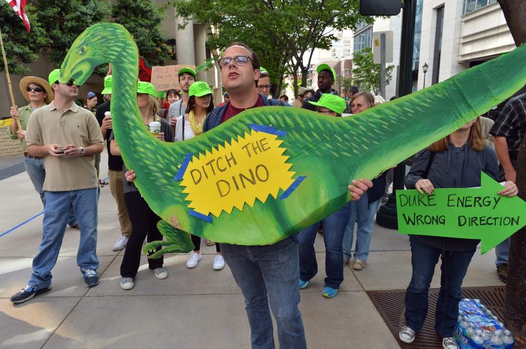 About 200 protesters carry signs and demonstrate in front of Duke Energy office building Thursday, May 1, 2014, as  shareholders held their annual meeting in Charlotte, N.C. Some Duke Energy investors plan to push the utility's board of directors to investigate issues surrounding a massive coal ash spill that dumped toxic sludge into a 70-mile stretch of a North Carolina river. (AP Photo/The Charlotte Observer, T. Ortega Gaines) MAGS OUT; TV OUT; NEWSPAPER INTERNET ONLY (REV-SHARE)