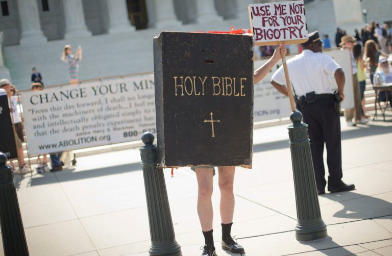 A demonstrator dressed as the Bible stands outside the Supreme Court building awaiting the court's decision on the Hobby Lobby case on Monday. (AP/Pablo Martinez Monsivais)