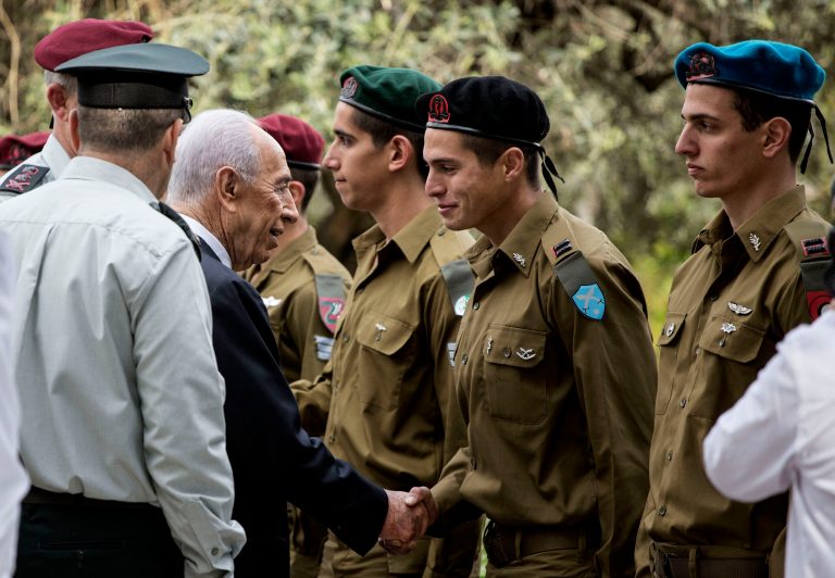 Israeli President Shimon Peres, shakes hands with soldiers during Israel's Independence Day celebration in Jerusalem, Israel, Tuesday, April 16, 2013. Israel is celebrating 65 years of independence with barbeques, air force flyovers, and a bible quiz. (AP Photo/Llia Yefimovich, Pool)
