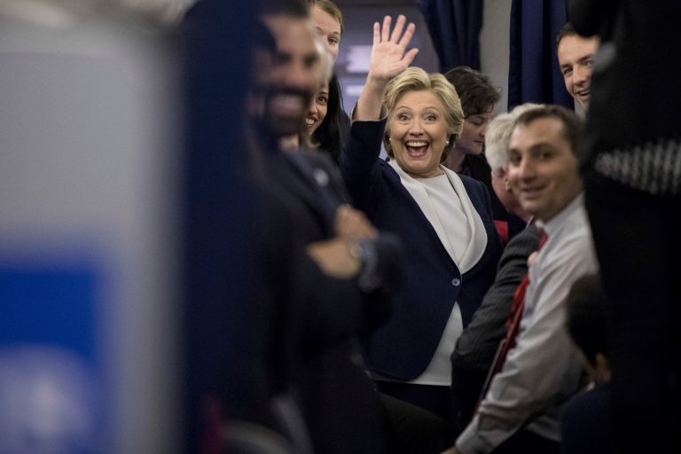 Democratic presidential candidate Hillary Clinton waves to members of the media while aboard her campaign plane. (AP Photo/Andrew Harnik)
