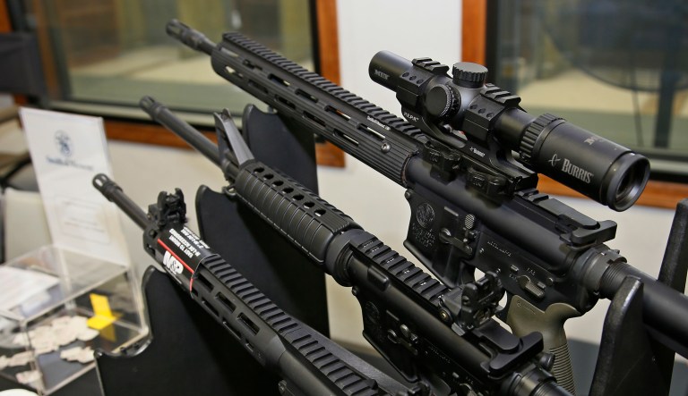 In this 2016 photo, a Smith & Wesson manufacturer display of AR-15 rifles is pictured during Summer Expo at H&H Shooting Sports in Oklahoma City. Now referred to as American Outdoors Brands Corporation, the company manufactured the AR-15 that was used in the mass shooting at Marjory Stoneman Douglas High School in Parkland, Fla. (AP Photo/Sue Ogrocki)