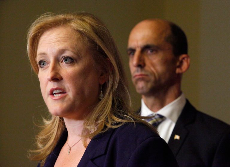 Canada's Transport Minister Lisa Raitt speaks to the media asth Minister of Public Safety Steven Blaney listens during a news conference on Parliament Hill in Ottawa, Tuesday, Aug. 16, 2014, following the release of the Transportation Safety Board's  report on the deadly Lac-Megantic train derailment in July 2013. (AP Photo/The Canadian Press, Patrick Doyle)