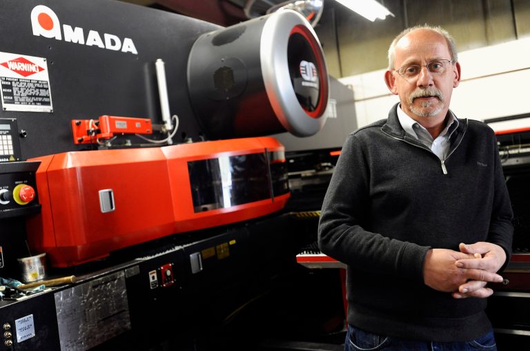 Lou Tashash, owner and president of R-D Manufacturing Inc., poses at his precision sheet manufacturing business in East Lyme, Conn. Tashash, who employs 14 workers, is lobbying legislators to kill a measure to establish a state-run pension plan, which he sees as a burdensome mandate. Lawmakers in Connecticut and other states are responding to a widespread loss of private-sector pensions, a lack of access to employer-sponsored retirement accounts in smaller businesses and stagnant incomes that make it hard for workers to contribute to their own retirement plan or company account. (AP Photo/Jessica Hill)