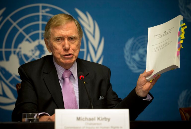 Retired Australian judge Michael Kirby, chairman of the commission of Inquiry on Human Rights in the Democratic People's Republic of Korea, shows the commission's report during a press conference at the United Nations in Geneva, Switzerland, Monday, Feb. 17, 2014. (AP Photo/Anja Niedringhaus)