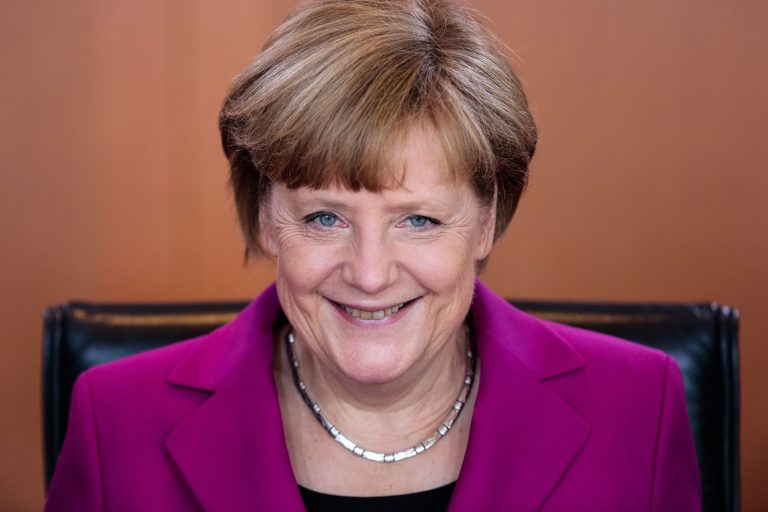 German Chancellor Angela Merkel smiles as she arrives for the weekly cabinet meeting at the chancellery in Berlin, Wednesday, June 4, 2014. (AP Photo/Markus Schreiber)