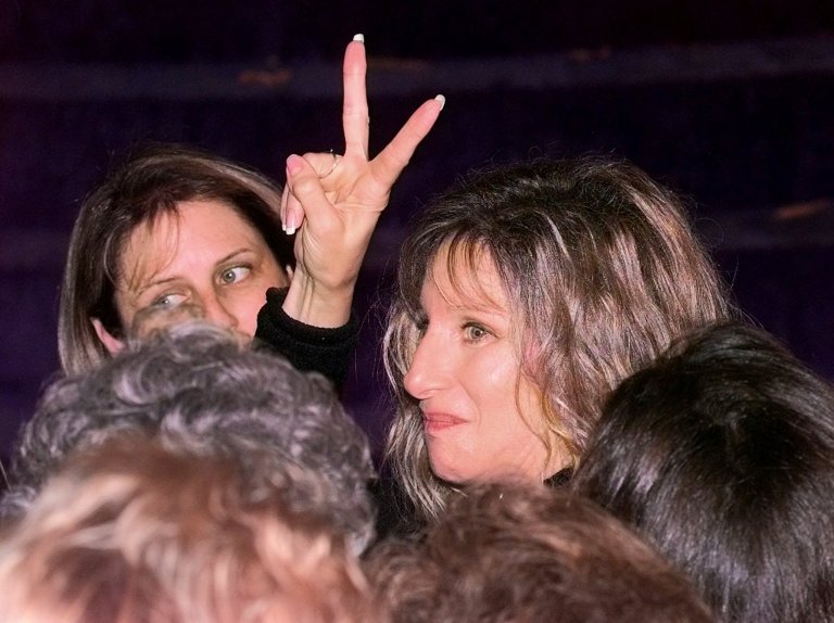 Entertainer Barbara Streisand gives a peace sign in a crowd of Clinton supporters at the the Old State House in Little Rock, Ark., Tuesday, Nov. 5, 1996. She just cut a new video for Hillary Rodham Clinton's campaign. (AP Photo/Rick Bowmer)