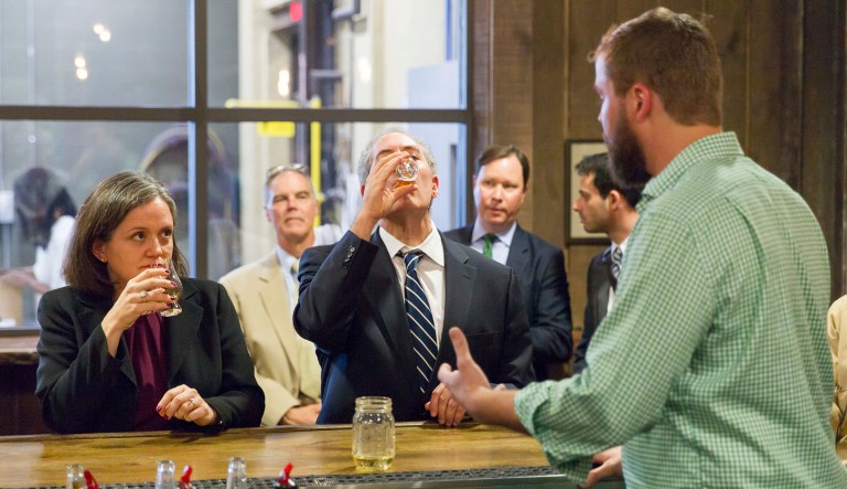 In this picture, then-U.S. Trade Representative Michael Froman (pictured in the center) samples whiskey at Green Brier Distillery in Nashville, Tenn., on Friday, Oct. 28, 2016. This photo opportunity might not have been possible, however, had Prohibition not been repealed in 1933. (AP Photo/Erik Schelzig)