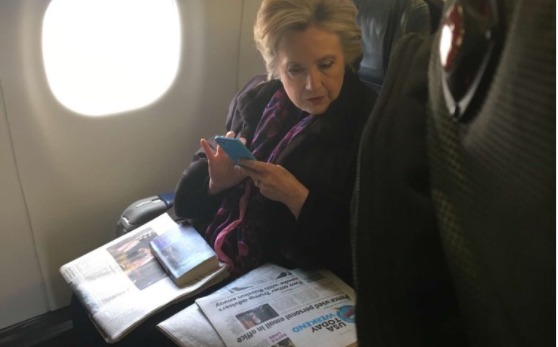 Hillary Clinton found on a plane, reading about Mike Pence’s emails