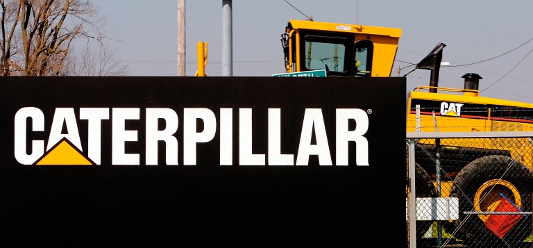 A Caterpillar grader is trucked out of the plant in Decatur, Ill. (AP/Seth Perlman)