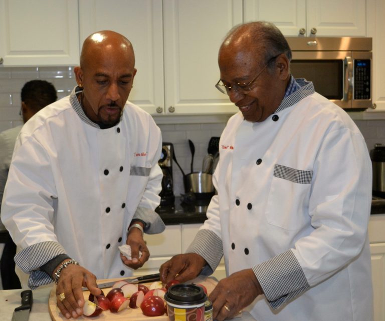 Montel Williams cooks with his dad, Herman, at the Fisher House on Thursday. 
