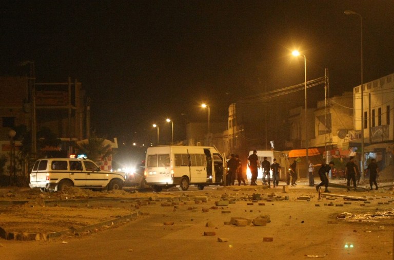   Rocks and debris litter a street in Sijouni, during overnight riots near Tunis, Tunisia, Tuesday, May 12, 2012. Tunisian police fired warning shots to disperse radical Islamist protesters after they set a security post ablaze and ransacked an art exhibit they called offensive to Islam. (AP Photo/Amine Landoulsi)  