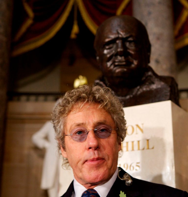 Performer Roger Daltrey poses in front of a bust of Winston Churchill before a ceremony to dedicate the bust in Statuary Hall of the U.S. Capitol in Washington, Wednesday, Oct. 30, 2013. (AP Photo/Molly Riley)