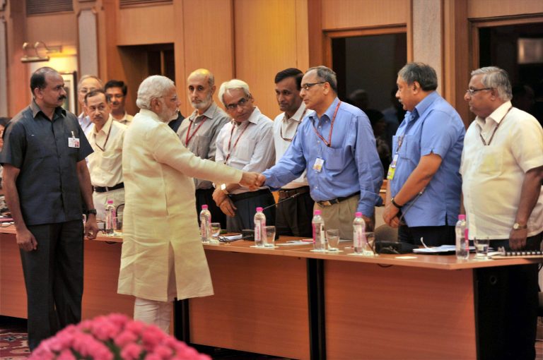 In this June 4, 2014 photo, Indian Prime Minister Narendra Modi, second left in front, interacts with bureaucrats before their meeting in New Delhi, India. The top civil servants in in India's labyrinthine bureaucracy these days, are spending their evenings paging through dictionaries, frantically looking up words. The dictionary searches stem from an order by new Prime Minister Modi: All official work must now be done in Hindi, the language spoken by about 45 percent of India's 1.2 billion people. In a country with as many as 22 official languages many question Hindi's dominance. (AP Photo)