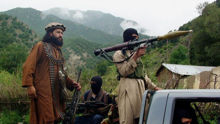 FILE - In this file photo taken on Aug. 5, 2012, Pakistani Taliban patrol in their stronghold of Shawal in Pakistani tribal region of South Waziristan. The Pakistani army said it has launched a 