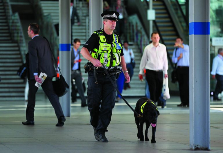 A police dog handler patrols at Stratford station near the Olympic Park, Monday, July 23, 2012, in London. The city will host the 2012 Summer Olympics which opens Friday, July 27. (AP Photo/Stephen Pond, PA) UNITED KINGDOM OUT
