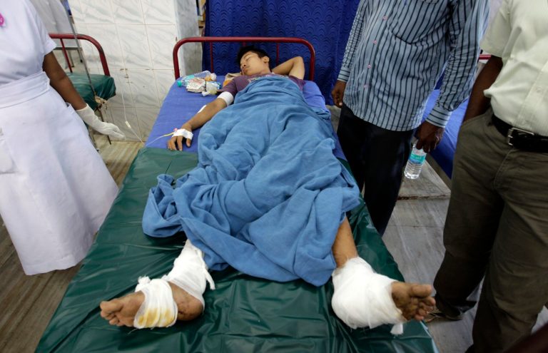 An injured passenger of a train blast receives treatment at a hospital in Chennai, India, Thursday, May 1, 2014. Twin blasts ripped through two coaches of a train Thursday morning just minutes after it pulled into Chennai railway station, killing a 22-year-old woman and injuring 14 people, officials said. (AP Photo/Arun Sankar K.)