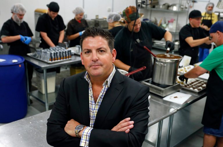 In this Sept. 25, 2014 photo, Tripp Keber, head of Denver-based Dixie Elixirs & Edibles, which makes pot-infused drinks, foods and other items, stands inside one of his edibles production kitchens at his manufacturing facility in Denver. Keber is among the entrepreneurs of the young U.S. marijuana industry who are taking another step into the mainstream, becoming political donors who use some of their profits to support cannabis-friendly candidates and ballot questions that could bring legal pot to more states. (AP Photo/Brennan Linsley)