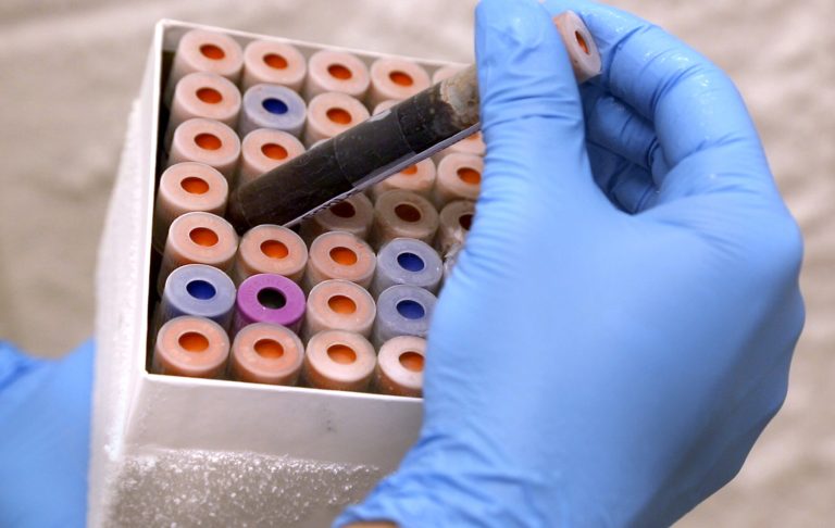   In this image provided by Duke University, lab research analyst Marshall Nichols does research relating to a new blood test on Tuesday, Sept. 17, 2013, in Durham, N.C. Duke University researchers are developing a blood test to more easily tell when a respiratory illness is due to a virus and not a bacterial infection, hoping to cut the dangerous overuse of antibiotics and speed the right diagnosis. (AP Photo/Duke Medicine, Shawn Rocco)  