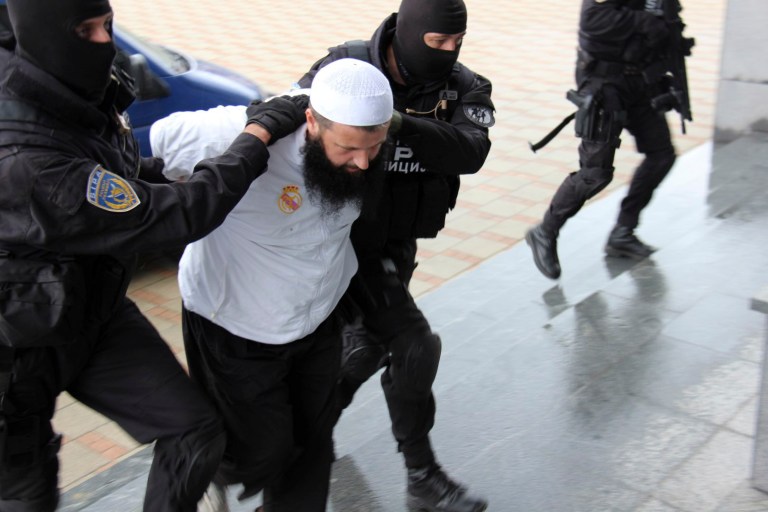 Bosnian police officers hold a suspected  man who was detained  during an action in the Bosnian capital of Sarajevo, on Wednesday, Sept. 3, 2014. Bosnian police say they have detained 15 people suspected of having fought in Syria and Iraq or of recruiting and funding other Balkan men to join the Islamic militants there. (AP Photo/Amel Emric)