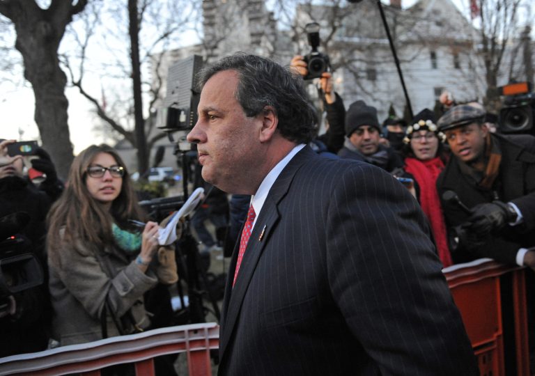 FILE - In this Thursday, Jan. 9, 2014, file photo, New Jersey Gov. Chris Christie walks past reporters as he leaves City Hall, in Fort Lee, N.J., after apologizing in person to Mayor Mark Sokolich. Moving quickly to contain a widening political scandal, Christie fired one of his top aides Thursday and apologized repeatedly for the 