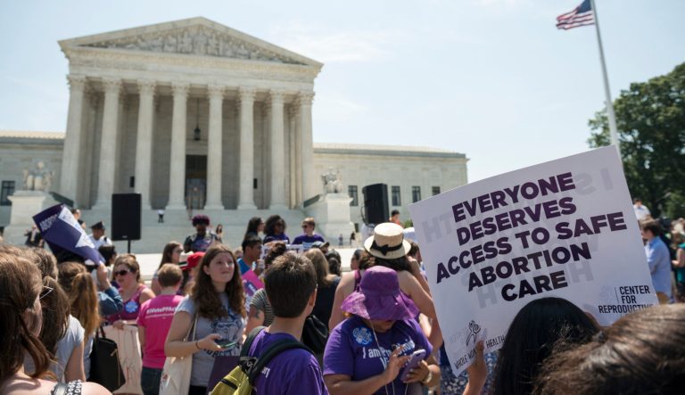 Pro-choice supporters stand in front of the U.S. Supreme Court after the court, in a 5-3 ruling in the case Whole Woman's Health v. Hellerstedt.