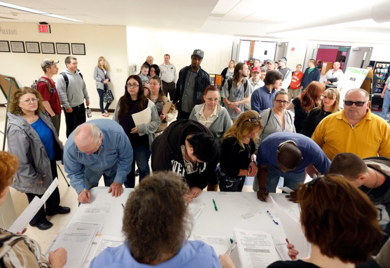 In this April 22, 2014 photo, job seekers line up for a job fair at Columbia-Greene Community College in Hudson, N.Y. The Labor Department reports the number of people who applied for unemployment benefits last week on Thursday, May 1, 2014. (AP Photo/Mike Groll)
