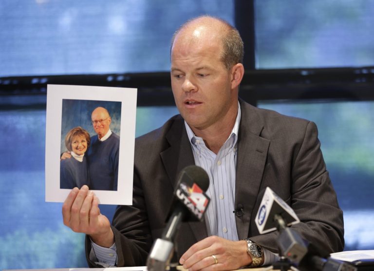 Attorney Paxton Guymon holds a photograph of Jim and Jan Harding during a news conference in Salt Lake City on Thursday, Aug. 14, 2014. Jan Harding, 67, is in critical condition at a Salt Lake City hospital's burn unit, unable to talk and fighting for her life, Guymon said. She drank sweet tea containing a toxic cleaning chemical, severely burning her mouth and throat at a Utah restaurant after an employee mistook the substance for sugar and mixed it into a dispenser, Guymon said. (AP Photo/Rick Bowmer) (AP Photo/Rick Bowmer)