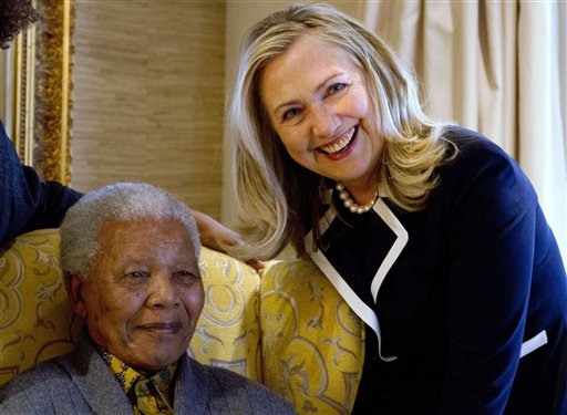 FILE - In this Aug. 6, 2012 file photo, U.S. Secretary of State Hillary Rodham Clinton, right, meets with former South Africa President Nelson Mandela, 94, at his home in Qunu, South Africa. (AP Photo/Jacquelyn Martin, Pool-File)