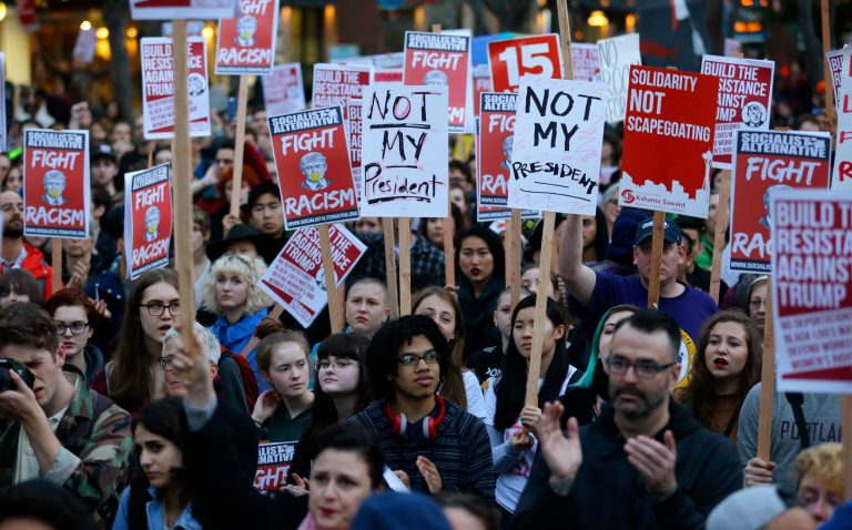 Tens of thousands of protesters took to the streets in seven major U.S. cities on Wednesday night to denounce President-elect Donald Trump. (AP Photo/Ted S. Warren)