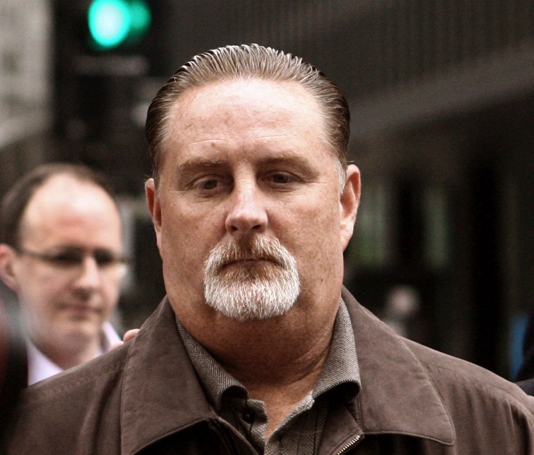 John Bills, 52, a retired Chicago official who managed one of the nation's largest red-light camera programs, leaves the federal building after an initial hearing in Chicago, Wednesday, May 14, 2014, after his arrest by federal authorities. Bills is accused of accepting hundreds of thousands of dollars in cash, an Arizona condominium and other gifts to steer $124 million in city contracts to Phoenix-based Redflex Traffic Systems, Inc.  (AP Photo/Sun-Times Media, Kevin Tanaka)  MANDATORY CREDIT, MAGS OUT, NO SALES