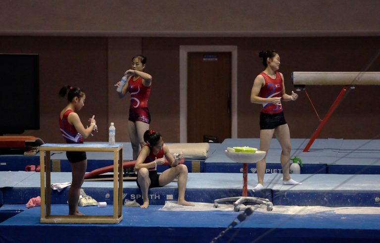 Athletes from a local gymnastics team break from training, Tuesday, Sept. 2, 2014 in Pyongyang, North Korea. In just over a week, North Korea will send its top athletes to win gold for their leader in what could well be the biggest sporting event of their lives and a major propaganda campaign for their nation, the Asian Games in Incheon, South Korea.(AP Photo/Wong Maye-E)