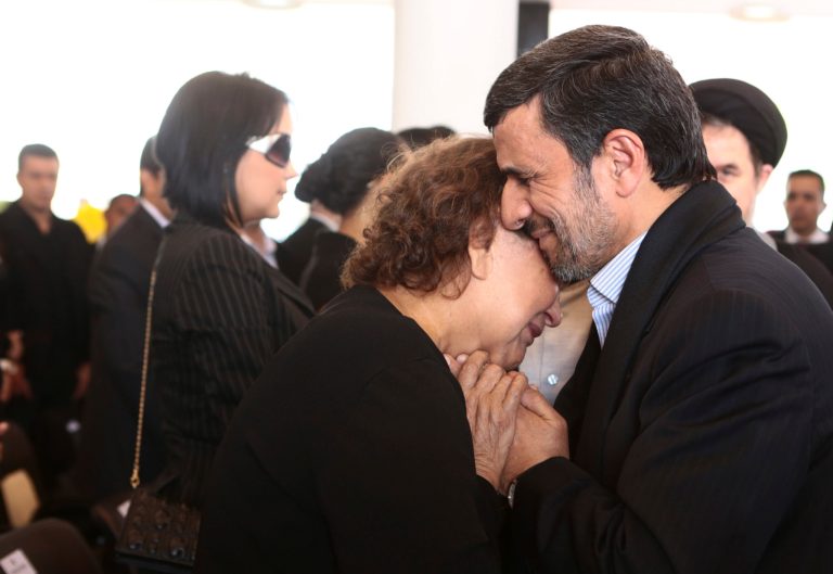 FILE --In this Friday, March 8, 2013 file photo released by the Miraflores Press Office, Iran's President Mahmoud Ahmadinejad comforts Elena Frias next to the flag-draped coffin of her son, Venezuela's late President Hugo Chavez, during the funeral ceremony at the military academy in Caracas, Venezuela. Senior Iranian clerics have criticized President Mahmoud Ahmadinejad for consoling Hugo Chavez's mother with a hug -- a physical contact considered a sin under the country's strict Islamic codes. (AP Photo/Miraflores Press Office, File)