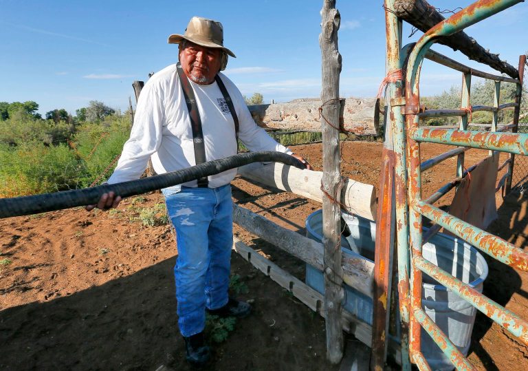 Richard Charley delivers water to a ranch along the San Juan River on the Navajo Reservation, Wednesday, Aug. 12, 2015, in Shiprock, NM. Toxic wastewater from the Gold King Mine in Silverton, Colo., has contaminated the San Juan River in Northern New Mexico from the runoff of the Animas River due to an accidental breach by a mining a safety team working for the Environmental Protection Agency last week. A 100-mile-long plume has since traveled for hundreds of miles, through parts of Colorado, New Mexico and Utah on the way to Lake Powell, a key source of water for the Southwest. (AP Photo/Matt York)